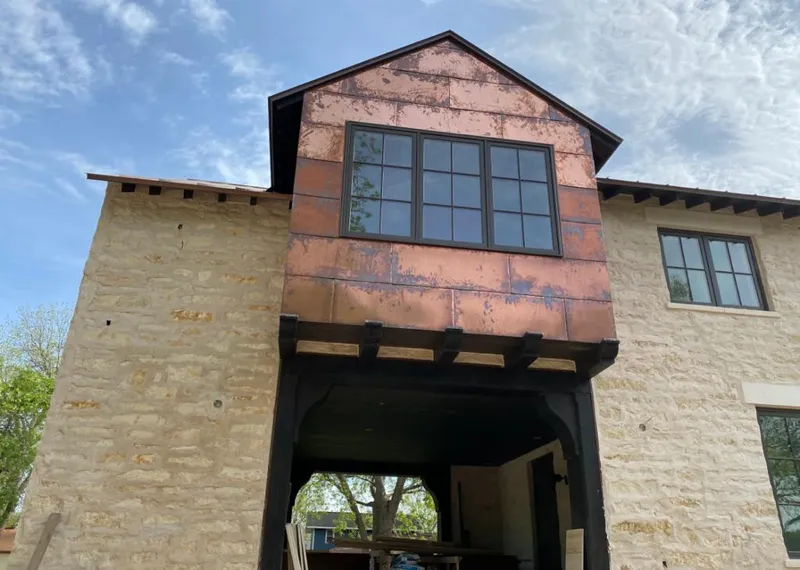 Copper metal panel facade on a stone building for Roof Repair in Madison Heights