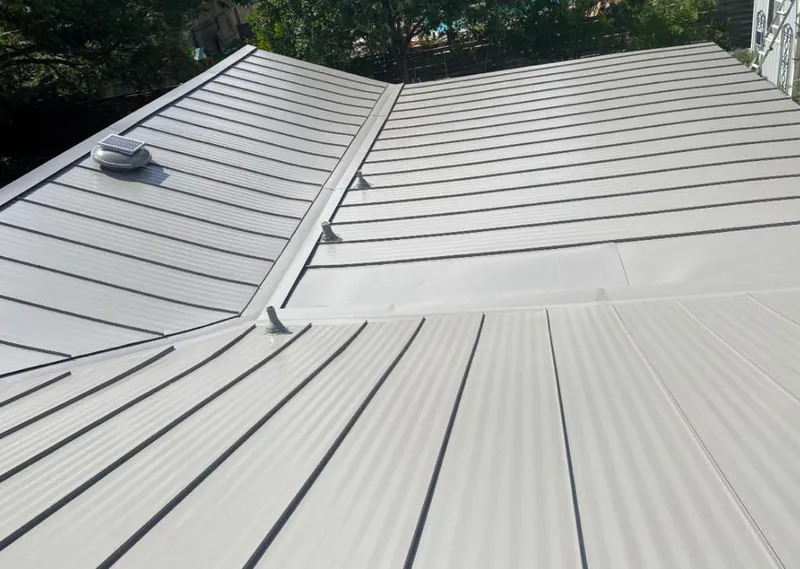 Solar attic fan installed on a metal roof for Roof Ventilation in Madison Heights